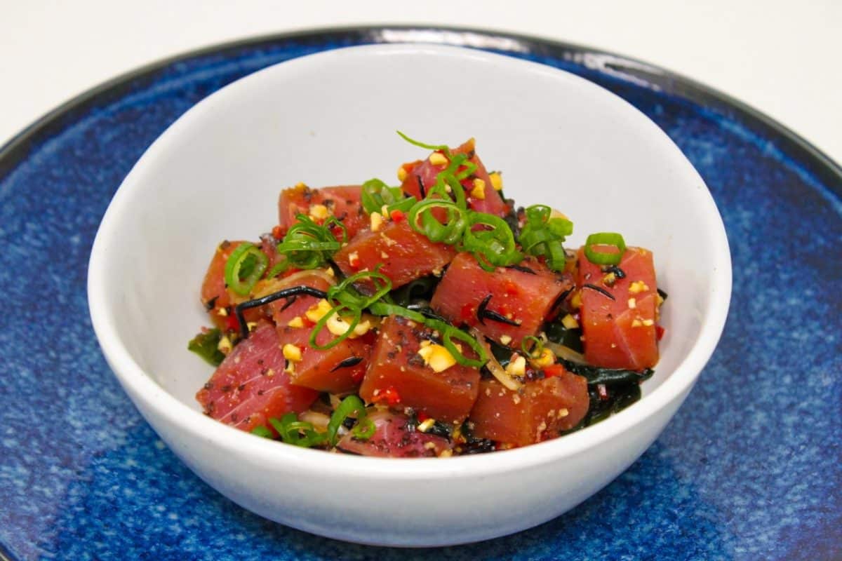 A close-up view of a Hawaiian-style Ahi Poke in a white bowl.