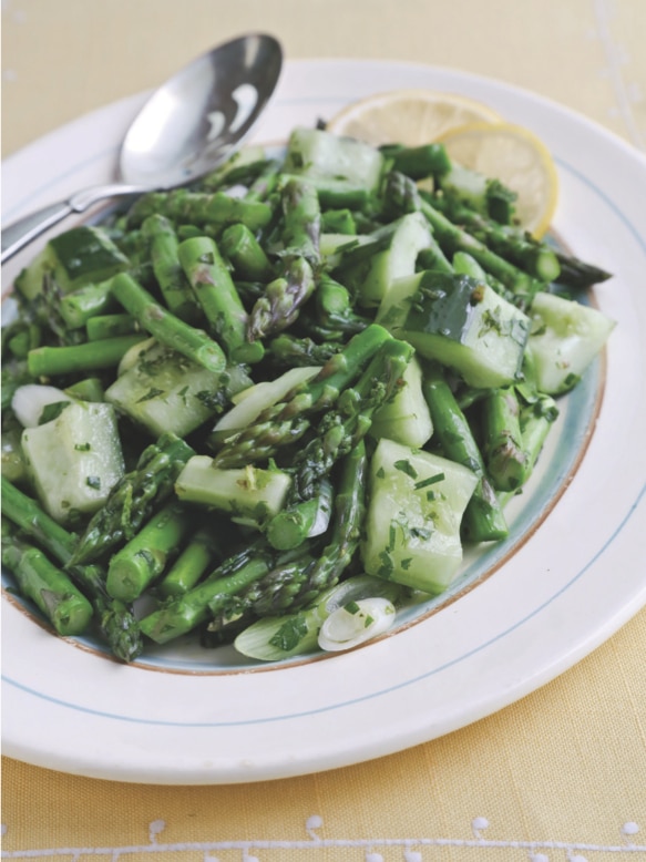 Fresh asparagus and baby vidalia onion salad served on a plate.