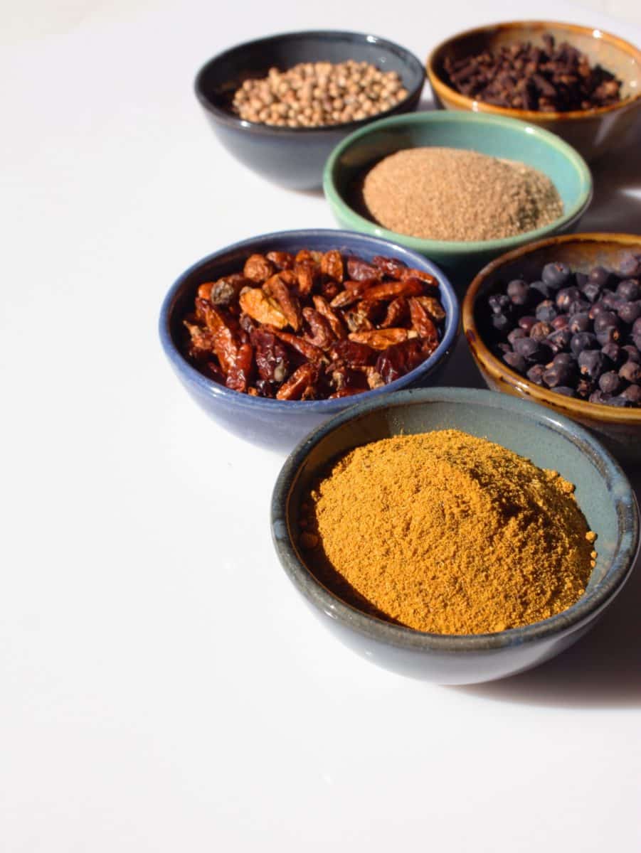 Variety of spices displayed in individual bowls.