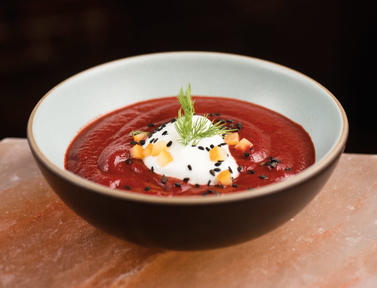 Beef and Beet Borscht garnished with nigella seeds and preserved lemon