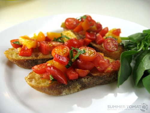 Toasted bread topped with diced tomatoes and herbs.