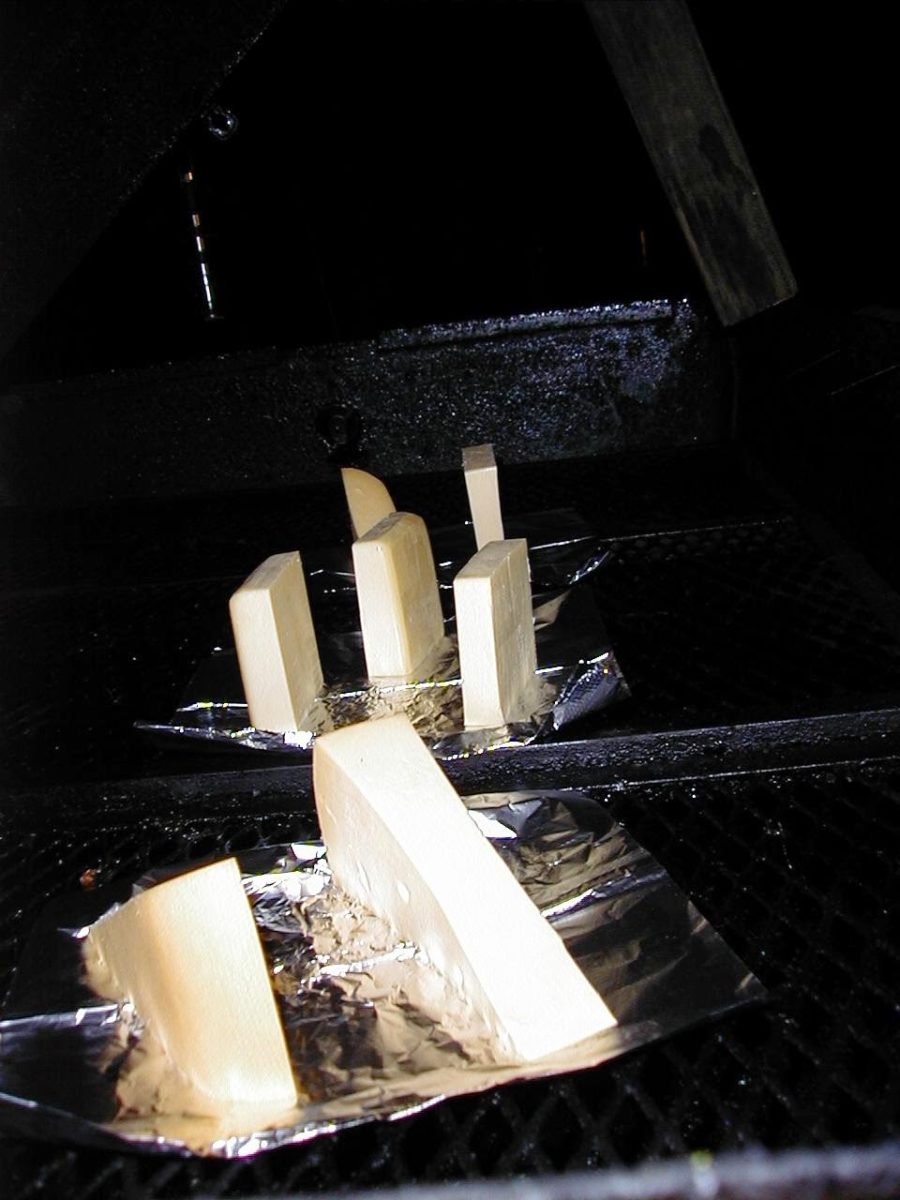 Blocks of cheese placed on a tray, ready for the smoking process.