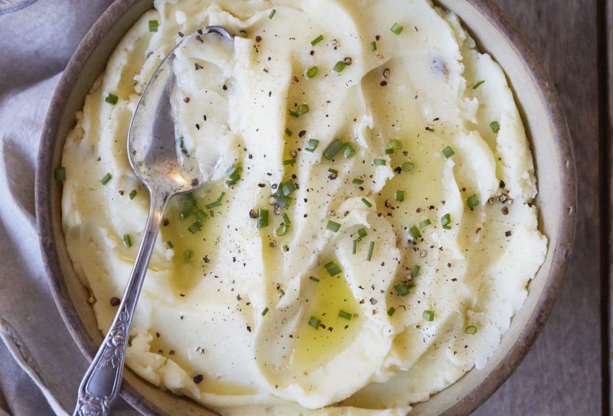 Close-up of creamy mashed potatoes garnished with herbs