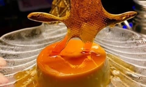 Close-up of a creme caramel dessert with a caramel splash.