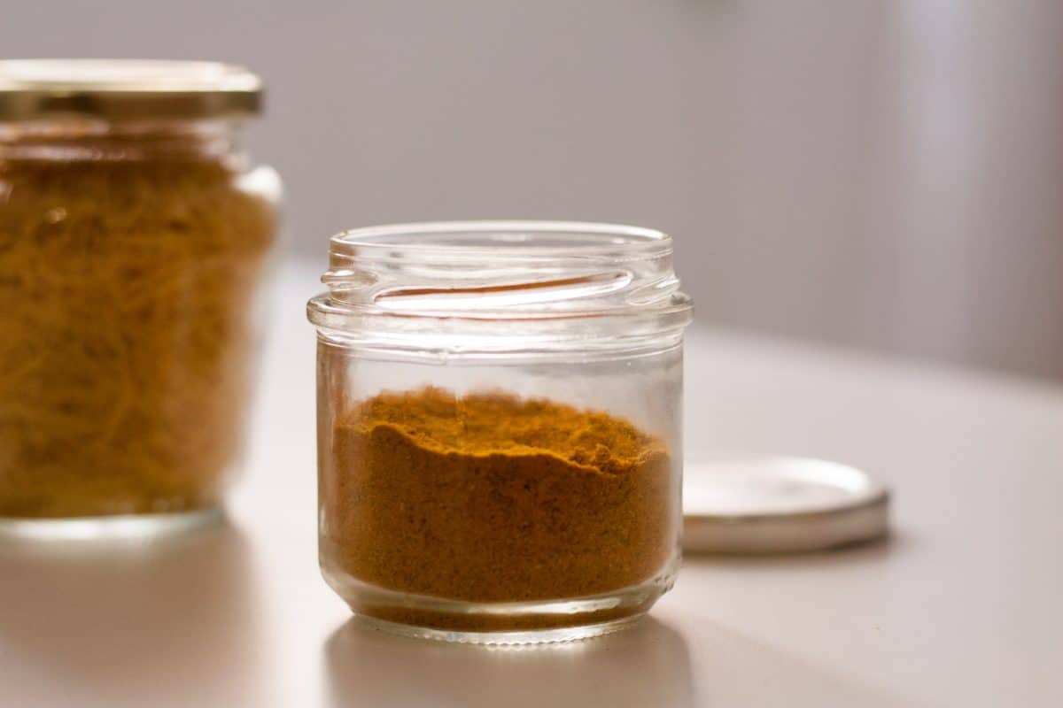 Two glass jars containing distinct spice blends.