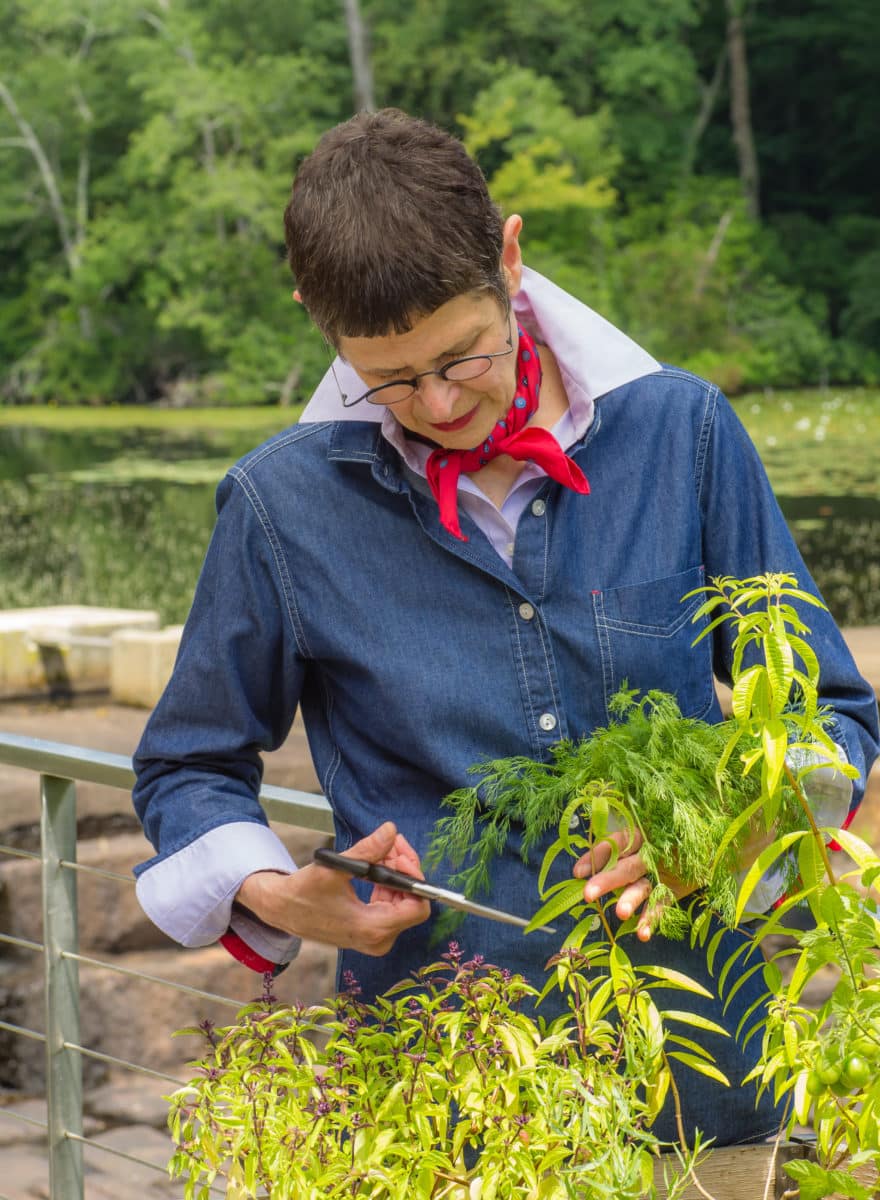 Dorie Greenspan snipping herbs
