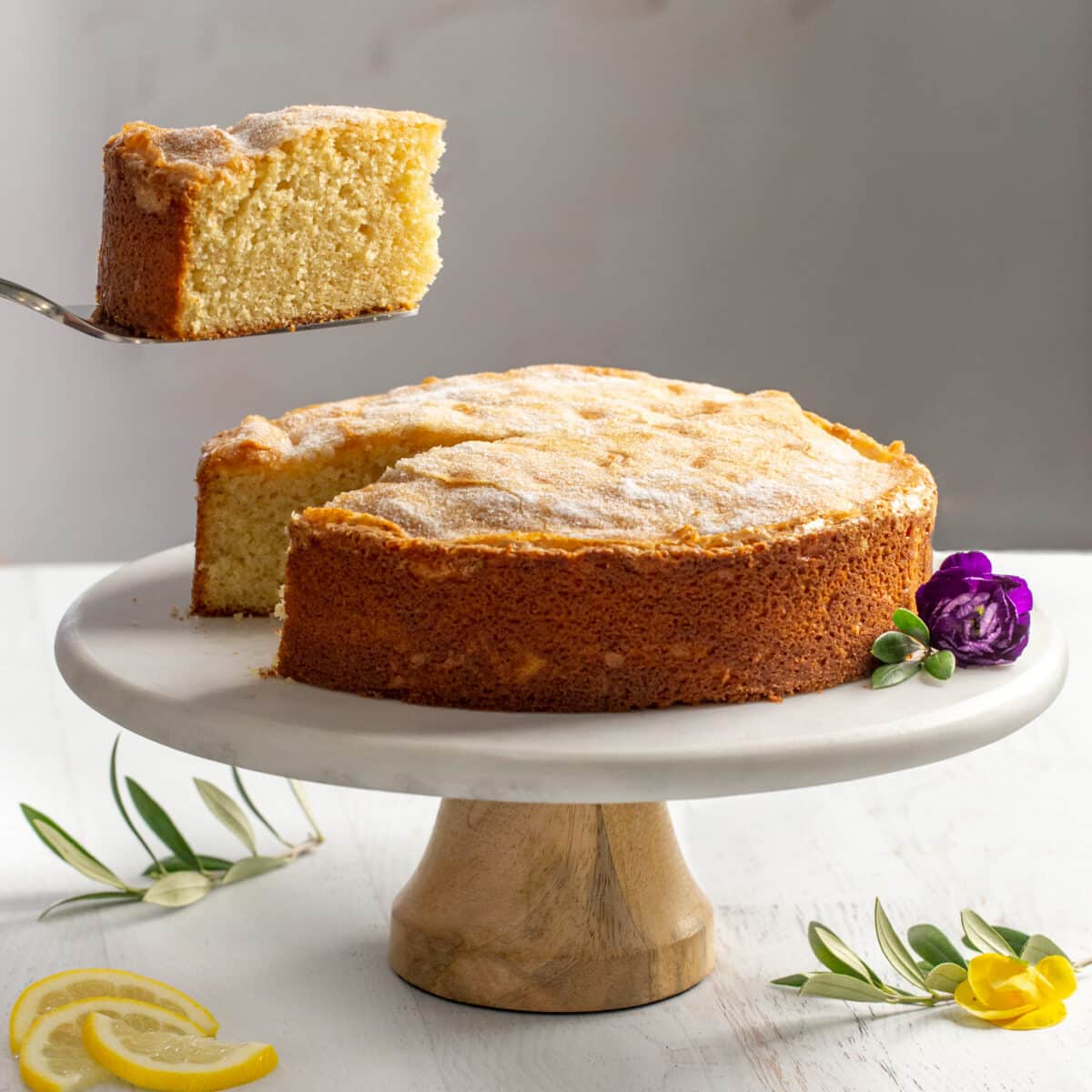 Flour and olvie oil cake on a stand with slice cut out