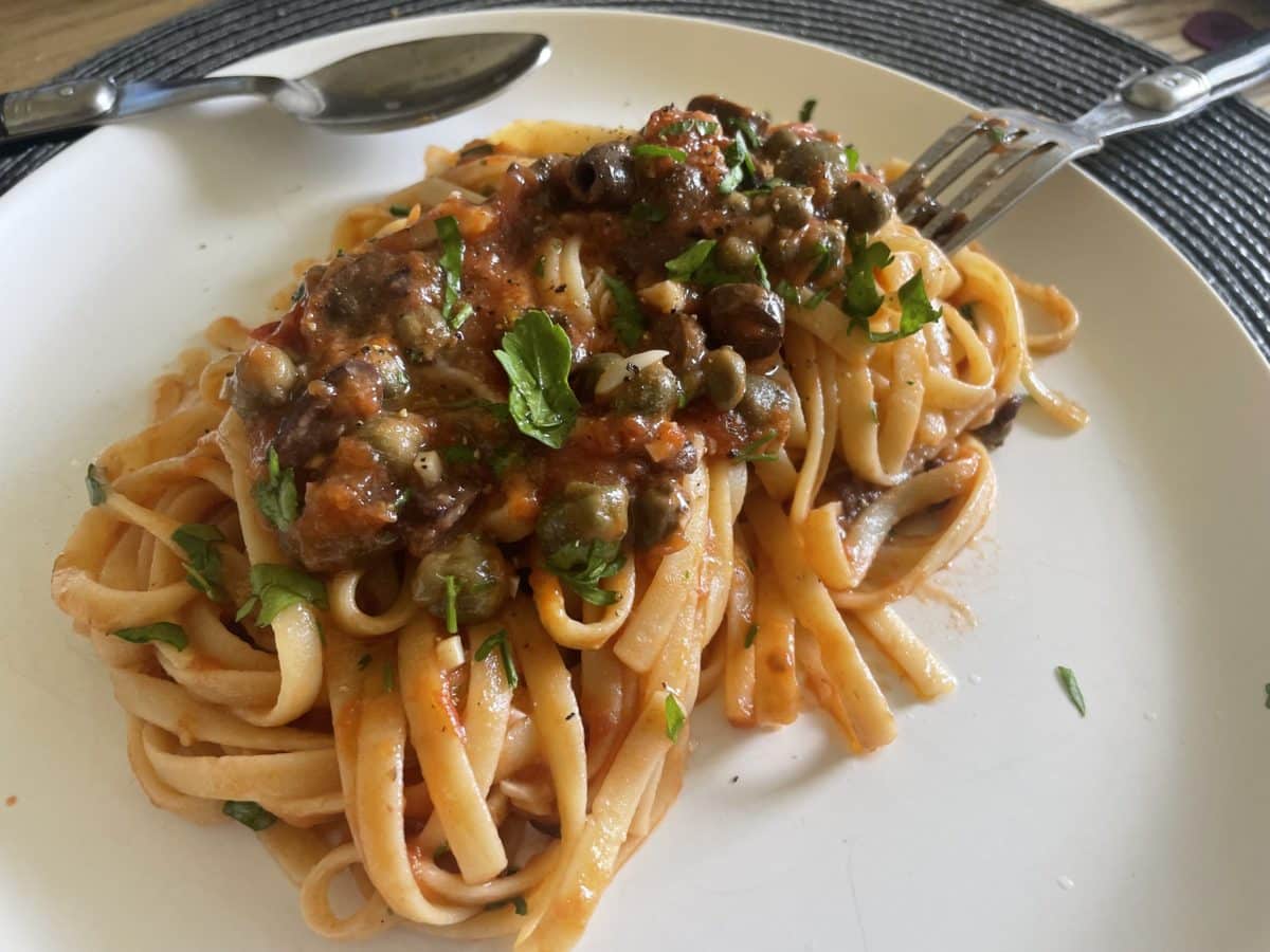 Freshly cooked linguine alla puttanesca on a plate