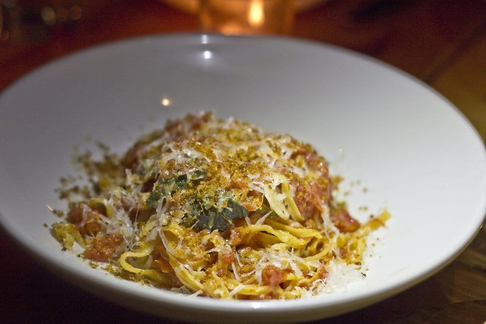 Plate of Maccheroni alla Chitarra pasta topped with cured San Marzano sauce.