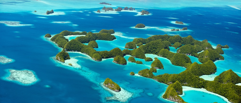 Aerial panoramic view of numerous islands with turquoise waters in Palau.