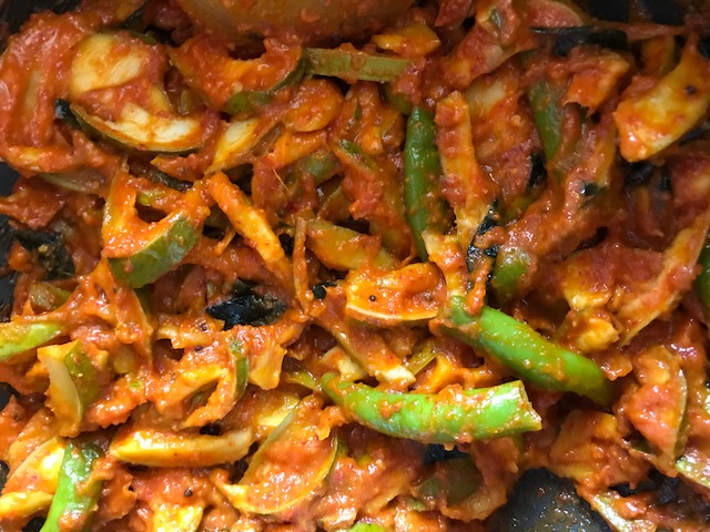 A pan filled with mango pickles.