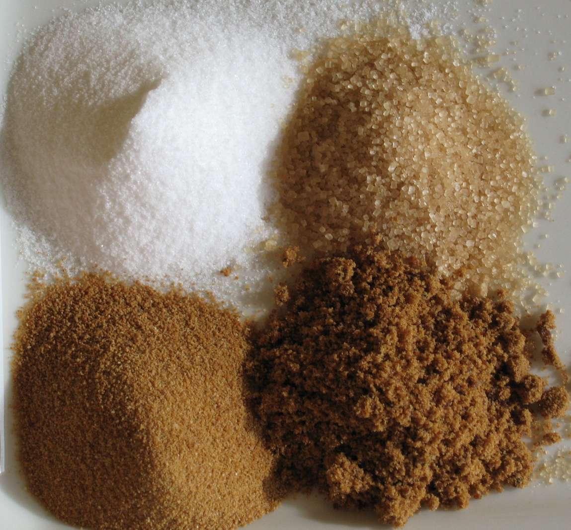 Different types of sugars displayed on a white plate