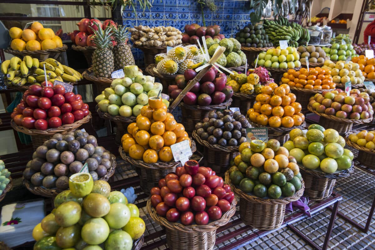 Tropical fruits in baskets at the Mercado dos Lavradores in the city centre of Funchal on the Island Madeira, Portugal.