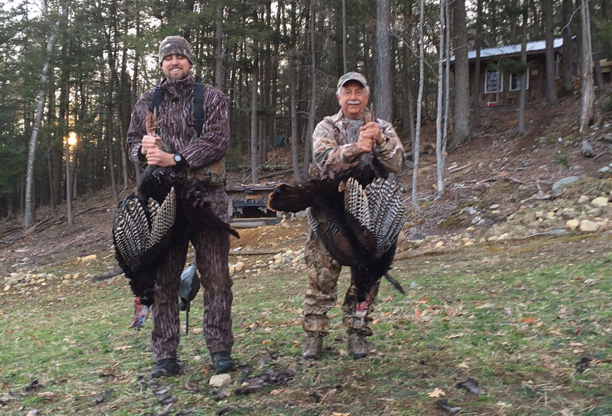Michael Yacino and Alex Cote each holding turkeys