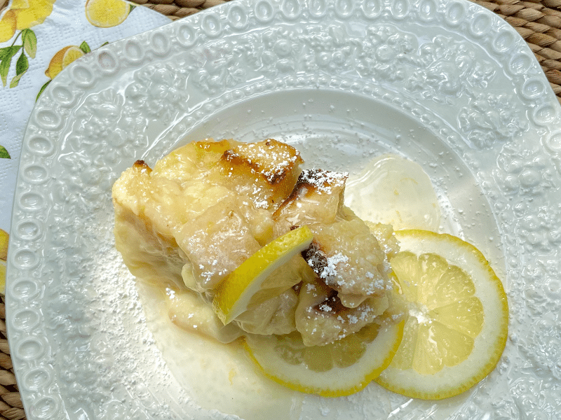 Bread pudding with lemon sauce on a plate