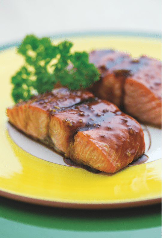 Succulent pieces of Chinese glazed salmon on a plate.