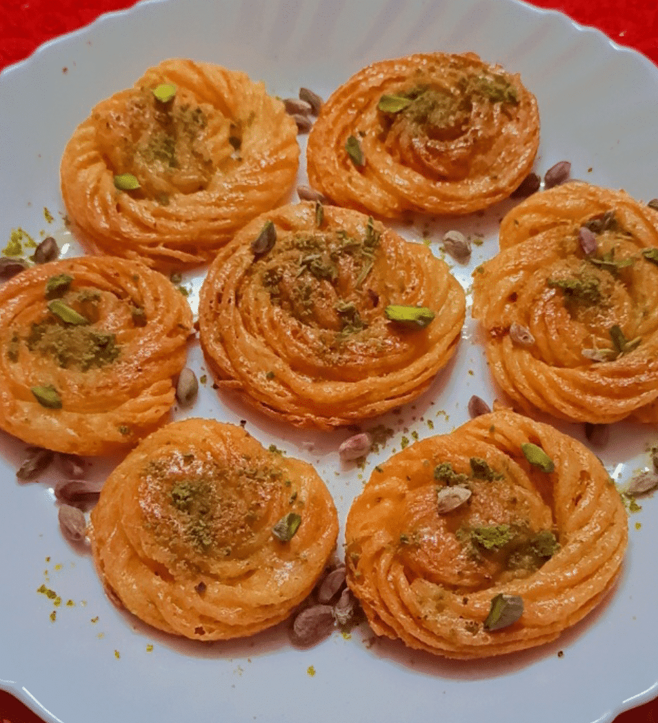 Close-up of paneer jalebis with pistachio toppings.